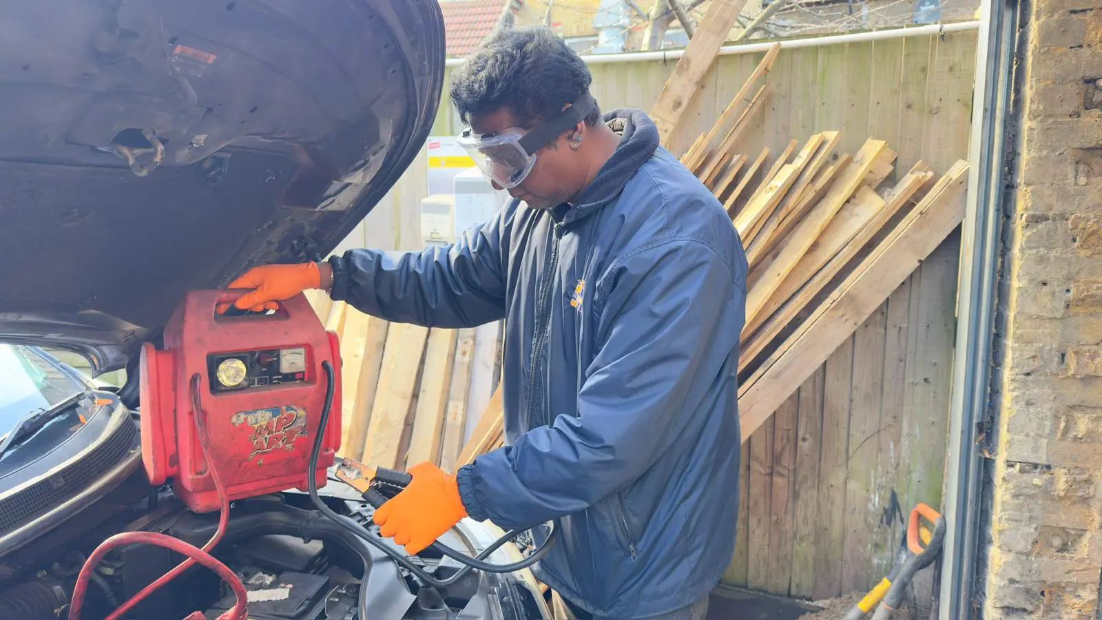 Safety equipment for jump starting including gloves, glasses, and proper jumper cables